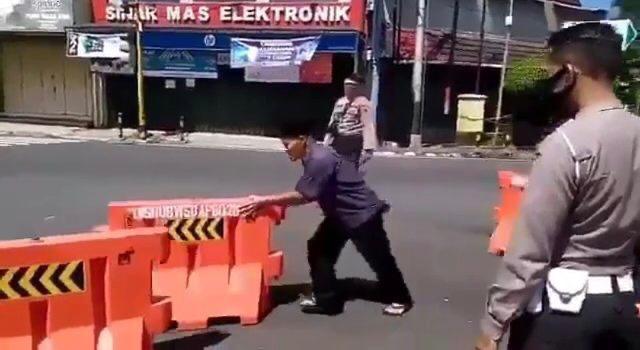 NGAMUK: Seorang pria di Wonosobo memindahpaksakan barikade jalan . (Sumber: tangkapan layar video)
