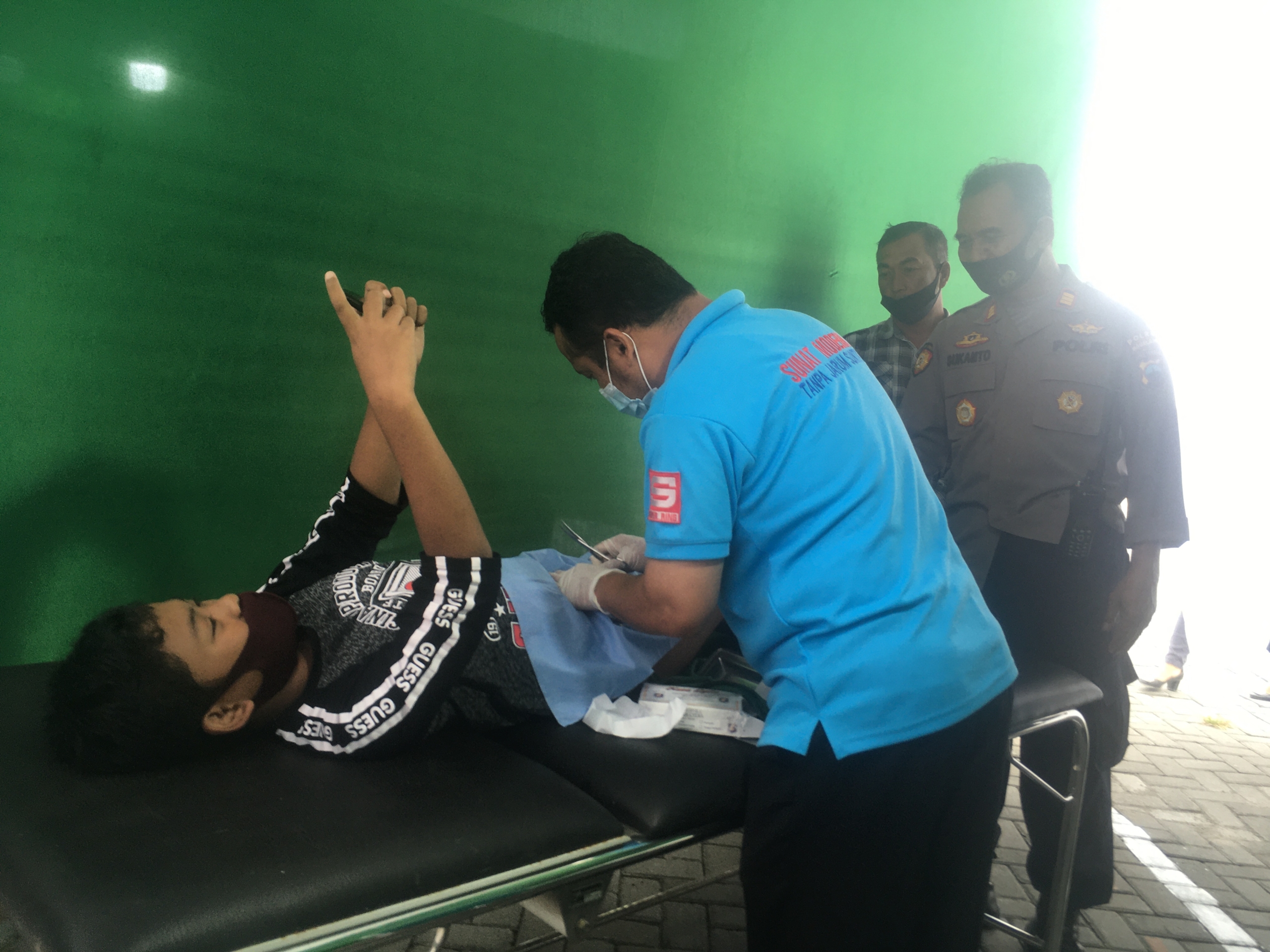 TIDAK SAKIT: Abed Priyan Perdana saat dikhitan sambil ngegim online di halaman halaman Cerita Kita Cafe, Kamis (10/6). (foto: han)