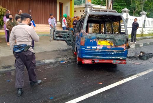 KORSLETING: Polisi mengamankan bangkai angkudes yang ludes terbakar. (Foto: ist)