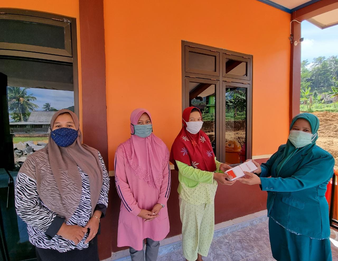 Ketua PKK Desa Pandanretno Kajoran saat mendistribusikan vitamin kepada warga