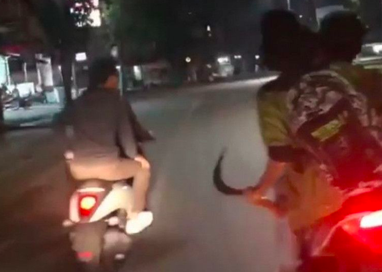 KRIMINAL: Sekelompok pria bermotor membawa senjata tajam saat melintas di jalan. (gambar: ilustrasi/ist)