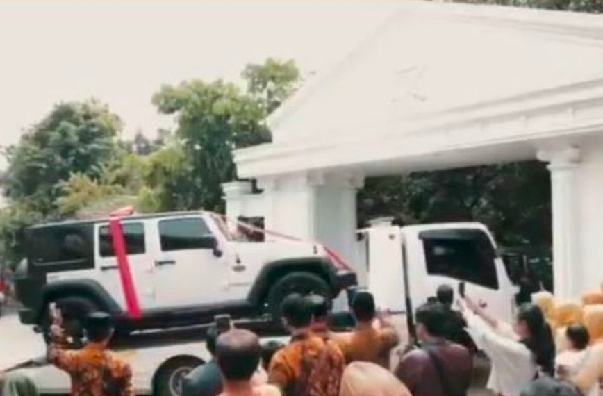 BERUNTUNG: Mobil Jeep Wrangler Rubicon dihiasi pita merah sebagai kado ulang tahun. (gambar: ist)