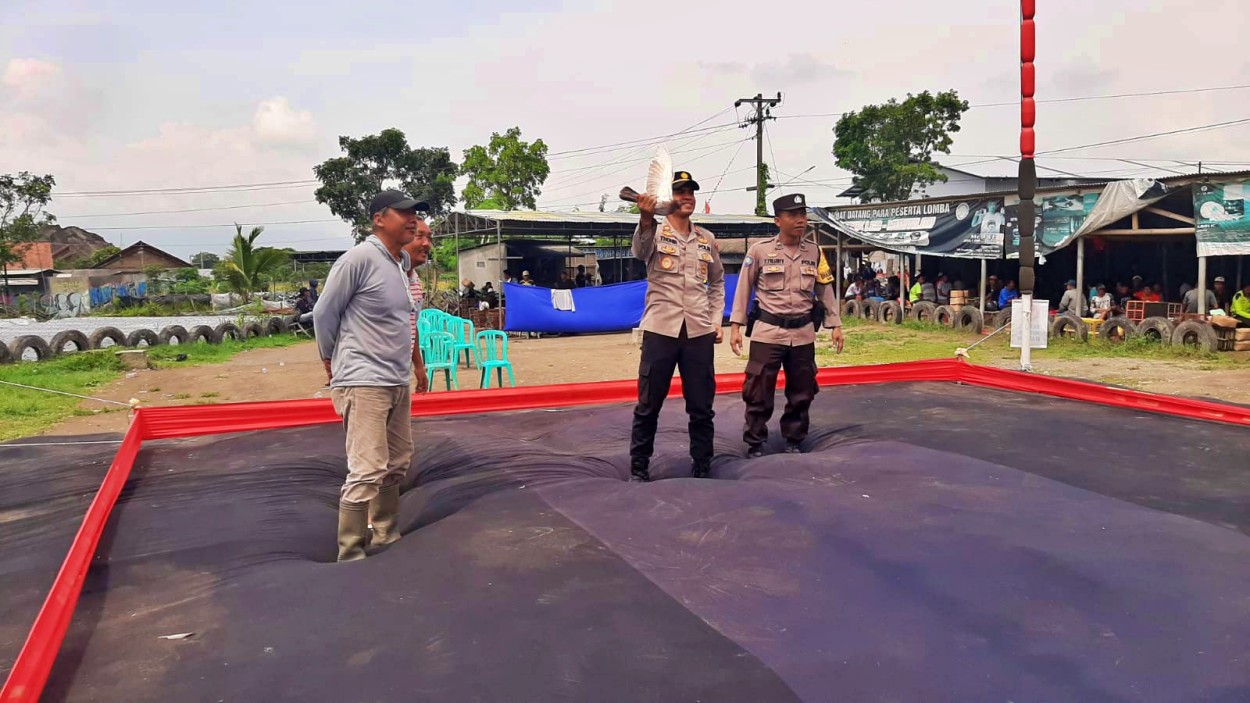 Kapolsek Muntilan saat mencoba burung merpati di lokasi acara adu cepat merpati